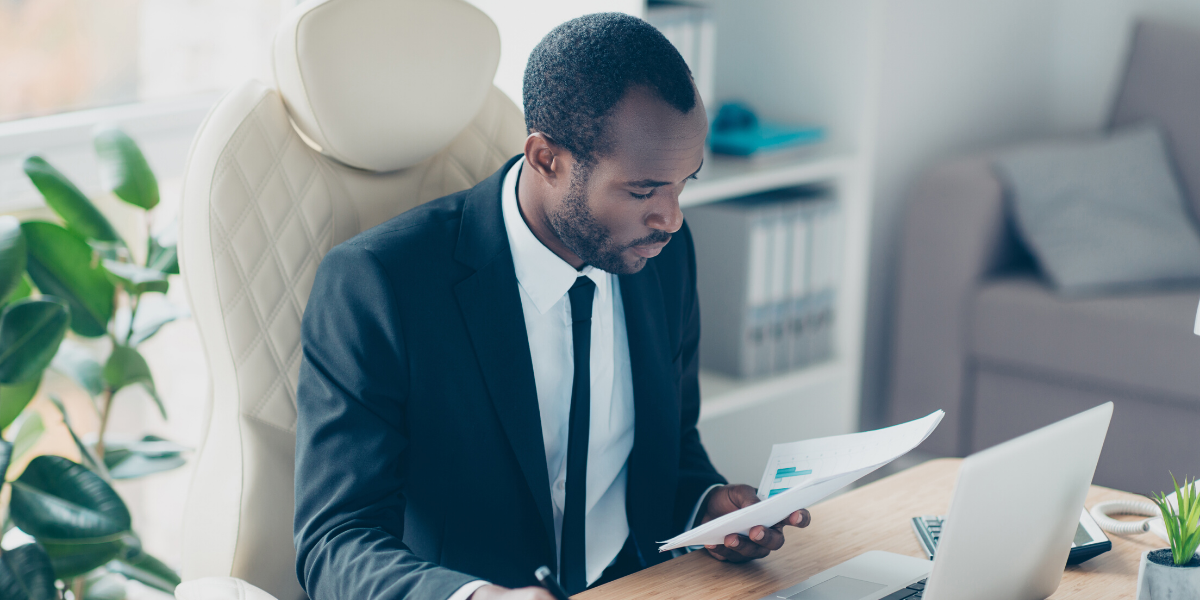 Map wearing suit in office works on laptop to build business argument map using mind map
